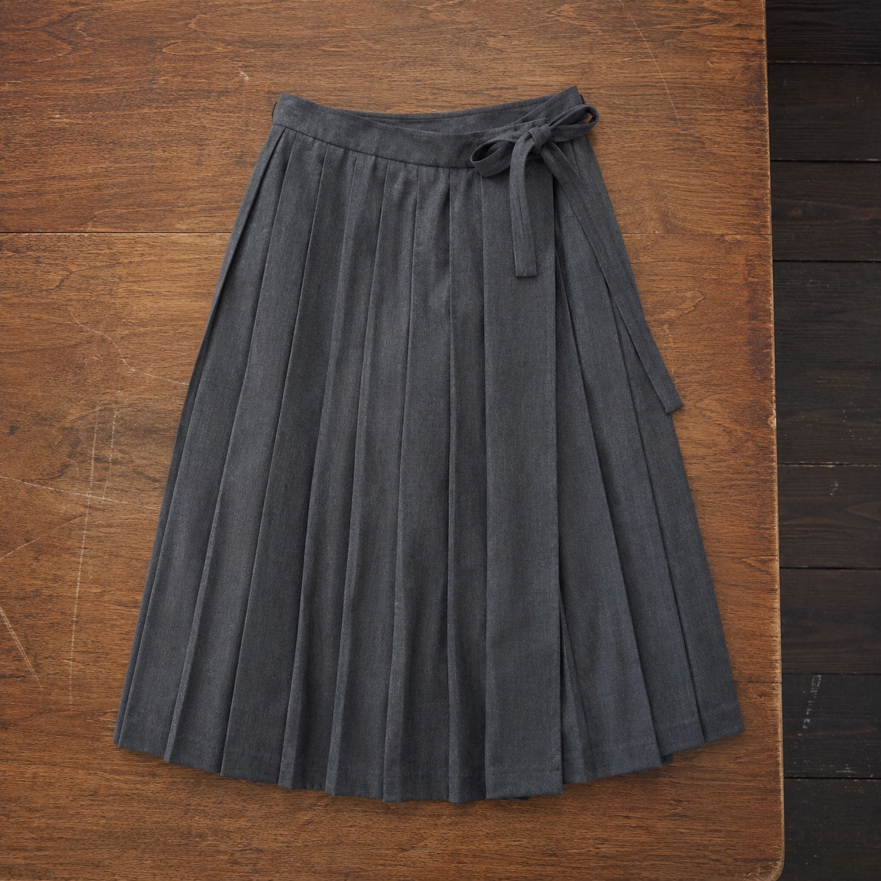 Cotswold box-pleated wrap skirt — Tailored Skirts by CROWN TAILORING. product photograph on a white background.