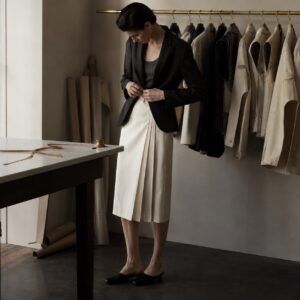 Ashdown box-pleated wrap skirt — Tailored Skirts by CROWN TAILORING. worn by a model.